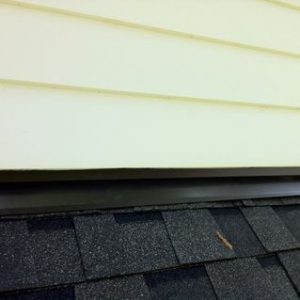A close up of the gutter on the side of a house