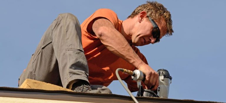 ima10 A man working on the roof of his house.